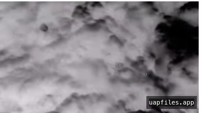 DOW-UAP-PR055, an infrared view of clouds with a small black round object