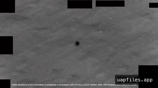 DOW-UAP-PR143, an infrared display over open water with a small dark round object